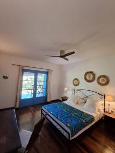 a bedroom with a bed and a window at Maison Orita in Nosy Be