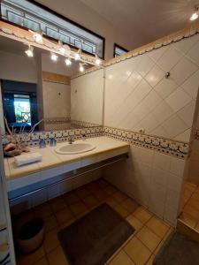 a bathroom with a sink and a mirror at Maison Orita in Nosy Be +24 photos