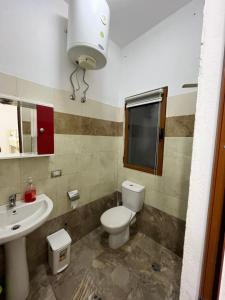 a bathroom with a toilet and a sink at Zefi Grill House in Lezhë