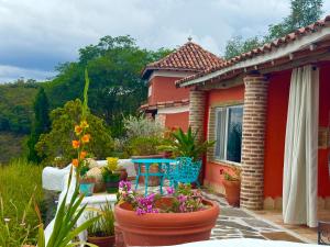 a house with a patio with flowers and plants at El Encanto Posada & Spa in Sabana Grande