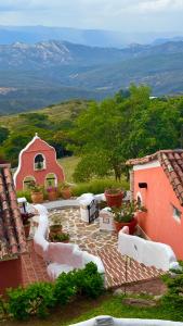 a patio with a table and chairs on top of a house at El Encanto Posada & Spa in Sabana Grande