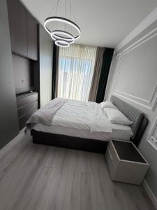a bedroom with a bed and a large window at Best Luxury Residence in Bistriţa