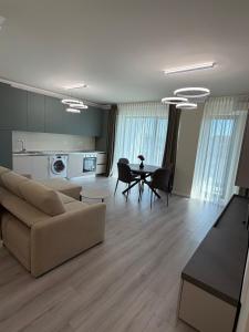 a living room with a couch and a table at Best Luxury Residence in Bistriţa