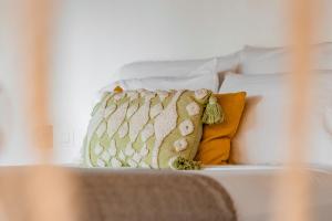 a white bed with two pillows and a blanket at Ca Nikte Cabañas in El Cuyo +80 photos