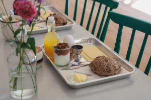 a table with a tray of food on a table at Albi's Sandvig Boutique Hotel in Sandvig +20 photos