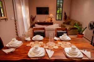 a wooden table with hats and plates on top of it at Villa Royfa in Mahajanga