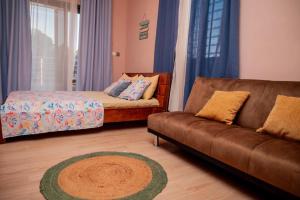 a living room with a couch and a bed at Villa Royfa in Mahajanga +10 photos