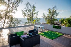 a patio with a table and chairs and the ocean at Villa Royfa in Mahajanga