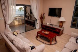 a living room with a couch and a table at Villa Royfa in Mahajanga