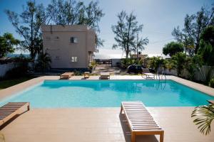a swimming pool in front of a house at Villa Royfa in Mahajanga