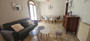 a living room with a couch and a table at Le logis de l'Ajolaise in Vielle-Aure