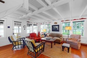 a living room with chairs and a couch and tables at Waterfront dog-friendly cottage with amazing views, deck, grill, & washer/dryer in Cushing