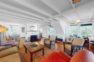 a living room filled with furniture and a fireplace at Waterfront dog-friendly cottage with amazing views, deck, grill, & washer/dryer in Cushing