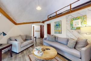 a living room with two couches and a table at Geodesic Dome w/ Riverfront Deck, Lovely Views, & High-Speed WiFi - Dogs Welcome in Boothbay