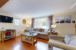 a living room with a couch and a table at Boothbay Harbor Home with Water Views | Near Dining & Whale Watching in Boothbay Harbor +17 photos