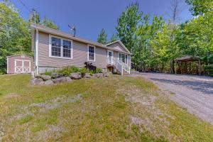 a house with a dog standing in front of it at Inviting dog-friendly home with firepit & Ping-Pong - near Acadia National Park in Ellsworth