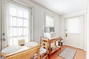 a room with a desk and a computer on a table at Downtown, ground floor studio near the ocean w/patio, outdoor dining area & more in Wiscasset