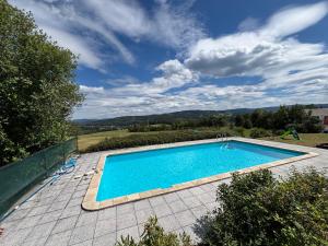 a swimming pool on a patio with a view of the mountains at Apartmán Kašperk in Vacov