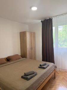 a bedroom with a bed with two towels on it at ZoViTe apartment in Topla