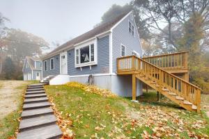 a house with a porch and a wooden deck at Boothbay Harbor Home with Water Views | Near Dining & Whale Watching in Boothbay Harbor
