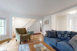 a living room with a blue couch and a chair at Charming Camden Retreat with Front Porch, Deck and Wifi in Camden