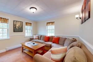 a living room with a couch and a table at Boothbay Harbor Home with Water Views | Near Dining & Whale Watching in Boothbay Harbor