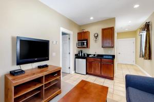 a living room with a flat screen tv and a kitchen at Cozy & Clean Second-Story Suite w/ Kitchenette & Free WiFi - Walk to the Harbor in Northeast Harbor