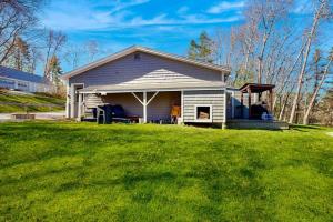 a small house with a lawn in front of it at Gorgeous Waterfront Home on Westport Island with 2 Sunrooms in Montsweag