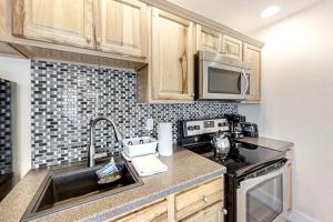 a kitchen with a sink and a microwave at Water-view condo at Sheepscot Harbour Resort with deck, full kitchen, and WiFi in Edgecomb +12 photos