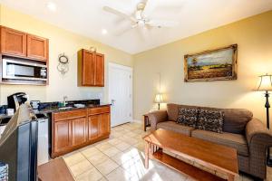 a living room with a couch and a kitchen at Two Neighboring Suites, Each w/ WiFi, Two TVs, and Central AC - Near Acadia in Northeast Harbor