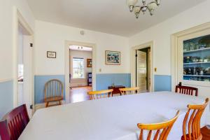 a dining room with a white table and chairs at Parker House: Historic home - walk downtown, dog-friendly & washer/dryer in Camden +16 photos