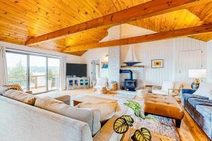 a living room with two couches and a fireplace at Renovated oceanfront home with stunning view & pebbly beach - snowbird-friendly in Saint George