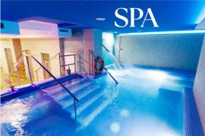 a swimming pool with a swimmer in the water at Hotel El Tajo & SPA in Ronda