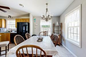 a kitchen and dining room with a table and chairs at Charming cottage near the beach with balcony, deck, grill, fireplace - dogs OK in Georgetown
