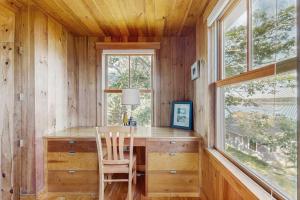 a home office with a desk and a window at Waterfront Paradise with Dock, Big Yard, Sundeck & Epic Bay Views | Dog-Friendly in Boothbay +14 photos