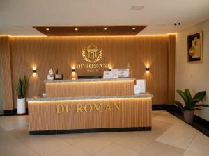 a hotel lobby with a dr roman sign on the wall at Hotel Diromani in Hernandarias