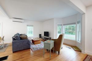 a living room with a couch and a table at Charming Camden Retreat with Front Porch, Deck and Wifi in Camden