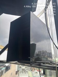 a television sitting on top of a window at Snal Spare Hotel in Ho Chi Minh City
