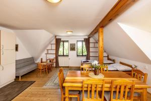 a dining room with a wooden table and chairs at Apartmány Havana in Český Krumlov