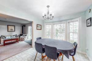 a dining room with a table and chairs at Idyllic waterfront home with furnished deck, grill, sweeping views & private W/D in Waldoboro