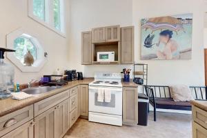 a kitchen with a sink and a stove top oven at Geodesic Dome w/ Riverfront Deck, Lovely Views, & High-Speed WiFi - Dogs Welcome in Boothbay