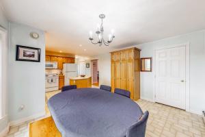 a dining room with a table and a kitchen at Idyllic waterfront home with furnished deck, grill, sweeping views & private W/D in Waldoboro +22 photos