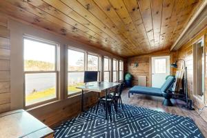 a room with a desk with a computer and chairs at Gorgeous Waterfront Home on Westport Island with 2 Sunrooms in Montsweag +22 photos