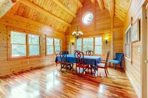 a dining room with a blue table and chairs at Tranquil Haven | Secluded waterfront house with sauna, dock, kayaks, canoe, gym in Greenville