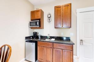 a small kitchen with a sink and a microwave at Lovely downtown Northeast Harbor suite near the water and near Acadia in Northeast Harbor