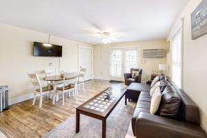 a living room with a couch and a table at Water-view condo at Sheepscot Harbour Resort with deck, full kitchen, and WiFi in Edgecomb