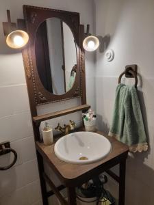 a bathroom with a sink and a mirror at Vega in Muñás