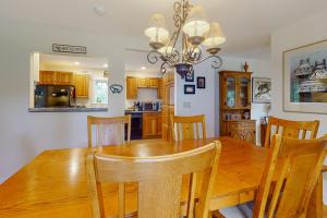 a kitchen and dining room with a wooden table and chairs at Gorgeous, walkable home with water view, deck & washer/dryer - snowbird-friendly in Camden