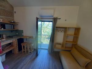 a room with a couch and a desk and a window at Quinta Pedra do Rio - Lérias in Salvador do Monte