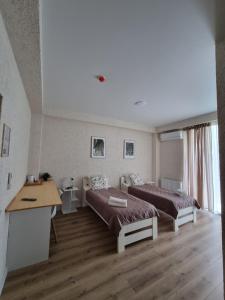 a room with two beds and a desk in it at Verde Resort in Ikalto +19 photos